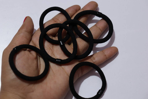 Black Color rubber bands on a white background - Fotó, kép