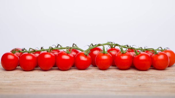 cherry tomatoes on white wooden table. close-up. - Foto, imagen