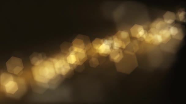 Defocused golden bokeh lights background. This elegant motion background animation with hexagonal lens blur bokeh particles is full HD and a seamless loop. - Imágenes, Vídeo