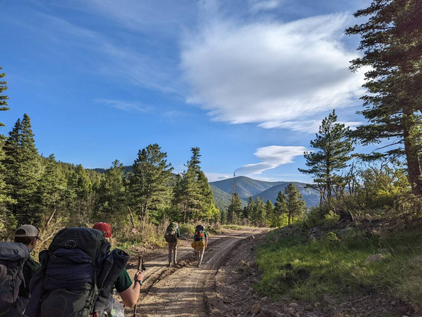 Hiking down a dirt road. Taken at Philmont Scout Ranch during the 2022 Summer Season - Photo, Image