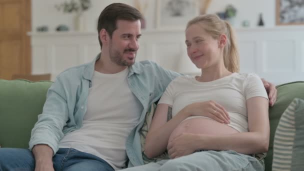 Happy Pregnant Young Couple Talking with Each other at Home - Imágenes, Vídeo