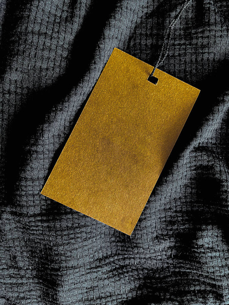 Blank fashion label tag, sale price card on luxury fabric background, shopping and retail concept - Fotografie, Obrázek