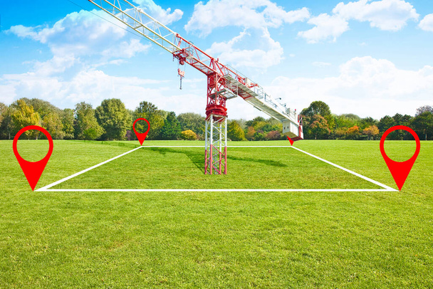 Land plot management - real estate concept with a vacant land on a green field available for building construction and tower crane - Foto, immagini