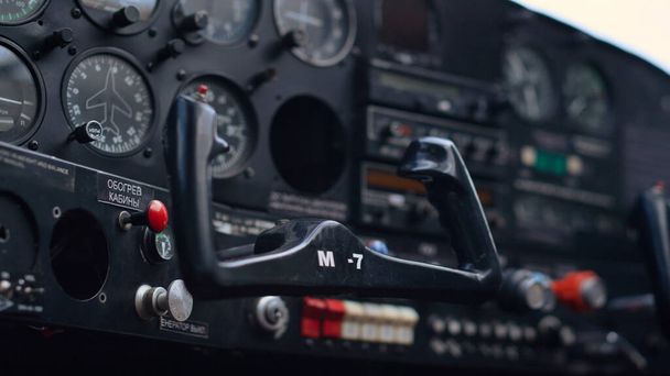 Modern airplane steering wheel inside small private aircraft cockpit close up. Technical control panel with buttons indicators in ultralight personal plane. Engineering aviation transport concept. - Foto, Imagem