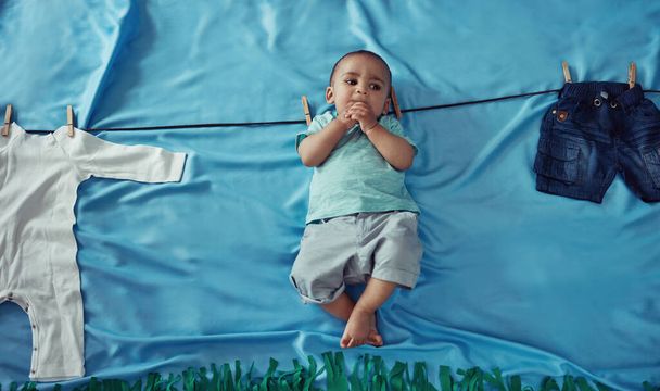 Getting a clean start in life. Concept shot of an adorable baby boy hanging on a make believe clothes line - 写真・画像