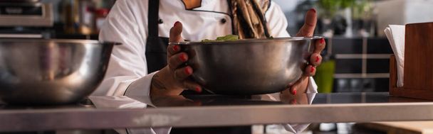 cropped view of tattooed african american woman holding bowl in professional kitchen, banner - Photo, image