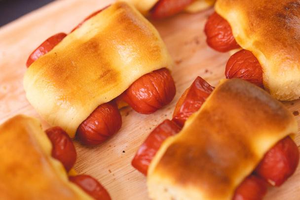Hot dog baked with bread dough (Syrian hot dog) or sausage roll in bread dough. Traditional salted in Brazil. Brazilian food. Hot dog. - Foto, Imagem