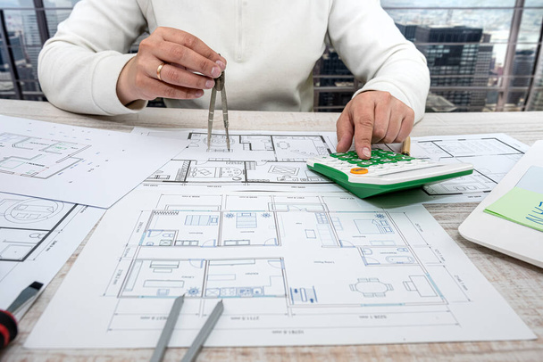a man working on a drawing to create his home with professional design skills. Design concept - Photo, image