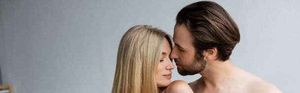 shirtless unshaven man near sexy blonde woman with closed eyes, banner - Photo, Image