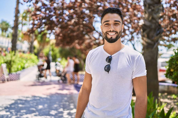 Young arab man smiling happy standing at the city. - Zdjęcie, obraz