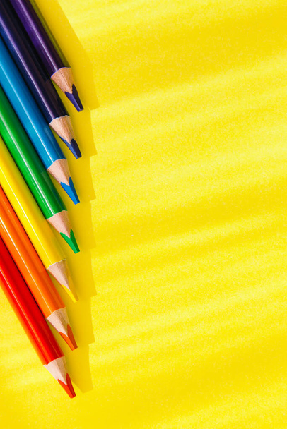 Set Of colorful wooden pencils on bright yellow background. Minimal style composition. Top view. Flat lay. Back to school concept - Foto, Imagen