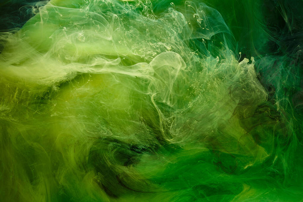 Liquid fluid art abstract background. Green dancing acrylic paints underwater, cosmic smoke ocean - Фото, изображение