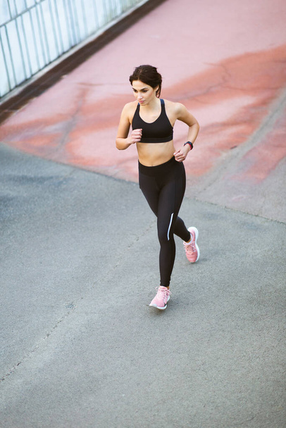 High angle portrait of healthy sportswoman doing running workout outdoors - 写真・画像