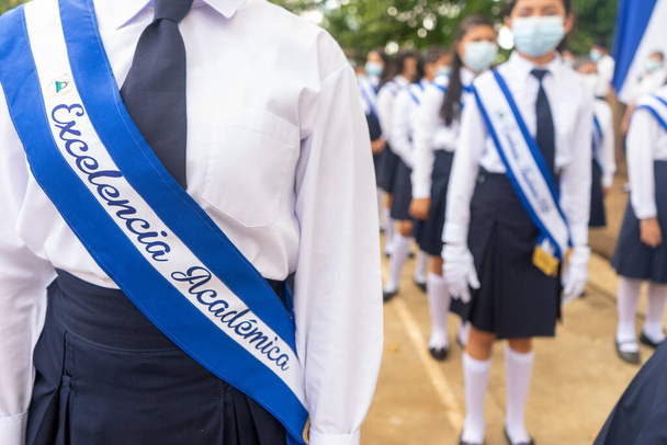 Unrecognizable Latin American teenagers students with bands of academic excellence written in spanish wearing uniform in Managua, Nicaragua - Foto, immagini