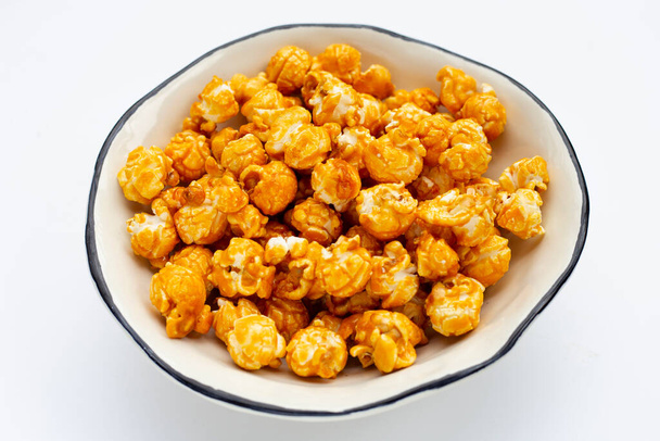 Honey caramel popcorn on white background. - Zdjęcie, obraz