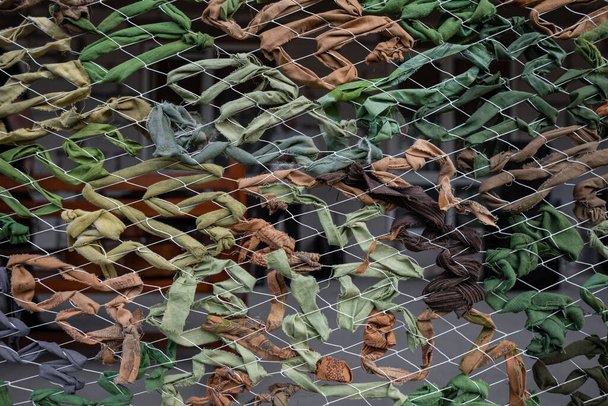 Mesh weaving. Camouflage grids. War in Ukraine. Shades of green. Khaki color. Military industry. - Foto, Imagen