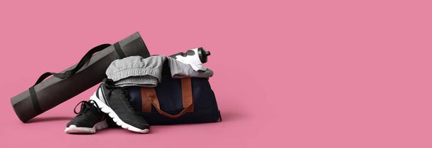 Sports bag, shoes and yoga mat on pink background with space for text - Fotografie, Obrázek
