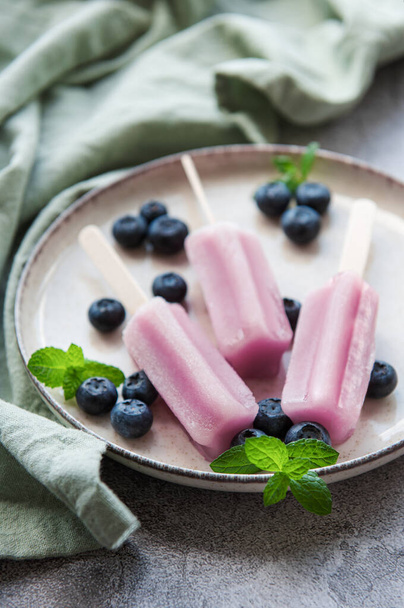 Ice cream popsicles from fresh organic blueberries. Summer sweets and desserts. Vegan food. - Photo, Image