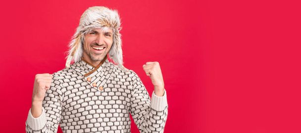 Man face portrait in winter warm hat, banner with copy space. successful handsome man wear sweater and winter hat, winter - Photo, Image
