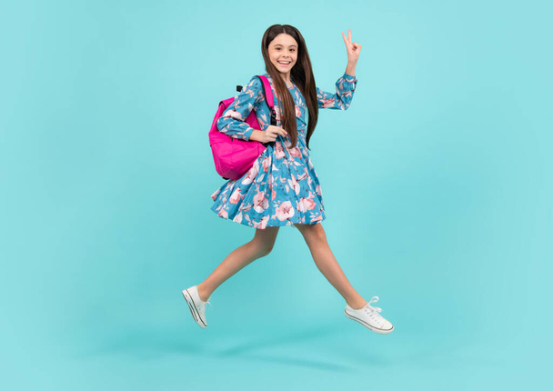 Back to school. Teenage school girl ready to learn. School children on blue isolated background. Run and jump. Happy teenager, positive and smiling emotions - Foto, Imagem