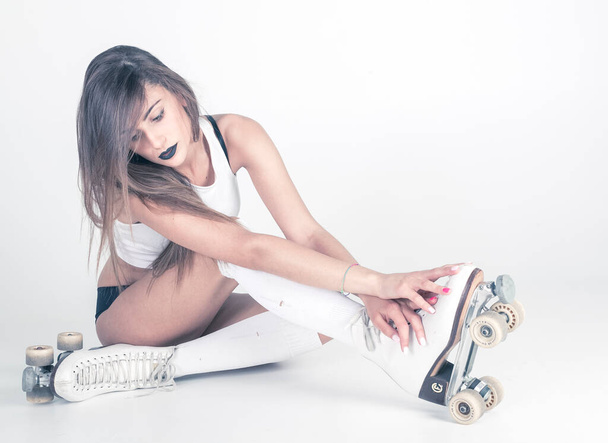 beautiful Italian girl posing with top and skates. High quality photo - 写真・画像