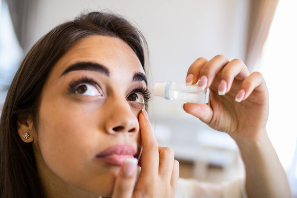 Vision And Ophthalmology Medicine. Closeup Of Beautiful Woman Applying Eyedrops In Her Eyes. Young Female Model With Natural Makeup Using A Bottle Of Eye Drops. Health Concept. High Resolution - Photo, Image