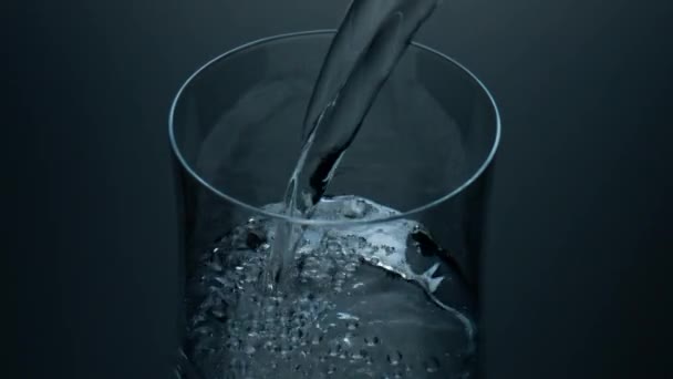 Pure water pouring cup closeup. Refreshing liquid bubbling filling glass jug. Mineral air bubbles rising surface. Cool drink soft beverage falling into container. Quenching thirst hydration concept. - Filmagem, Vídeo