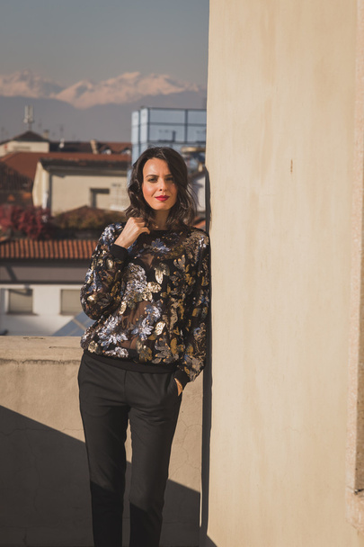 Portrait of a beautiful young brunette posing on a balcony - Fotoğraf, Görsel