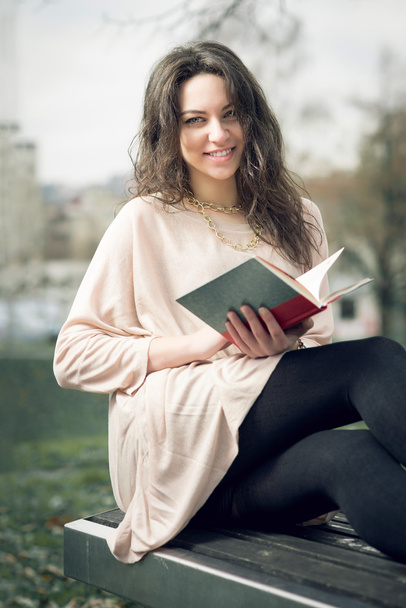 Girl reading a book in park - Zdjęcie, obraz