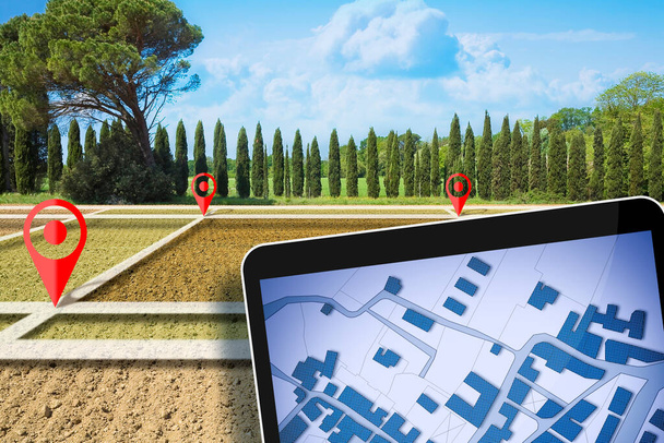 Land plot management - real estate concept with a vacant land on a plowed agricultural field available for building construction and digital tablet with imaginary cadastral map - Fotó, kép
