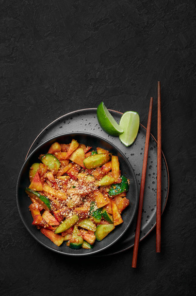 Penang Rojak in black bowl on dark slate table top. Malaysian or indonesian cuisine fruits and vegetables salad dish. Asian Food. Top view. Copy space - Photo, Image
