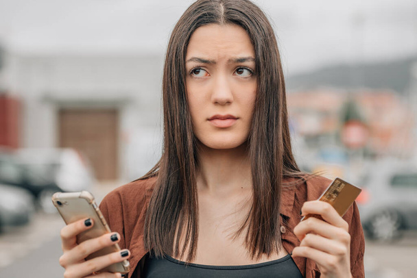 girl with mobile phone and card buying online - Fotó, kép