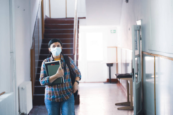 Student with face mask back at college or university, coronavirus concept. - Photo, Image