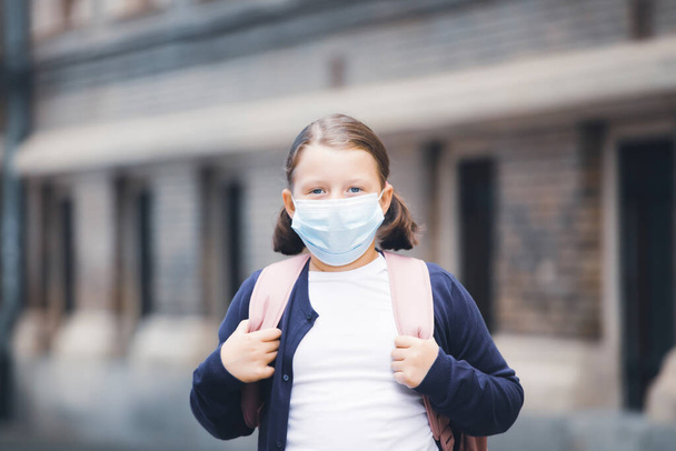 Child with face mask going back to school  - Photo, Image