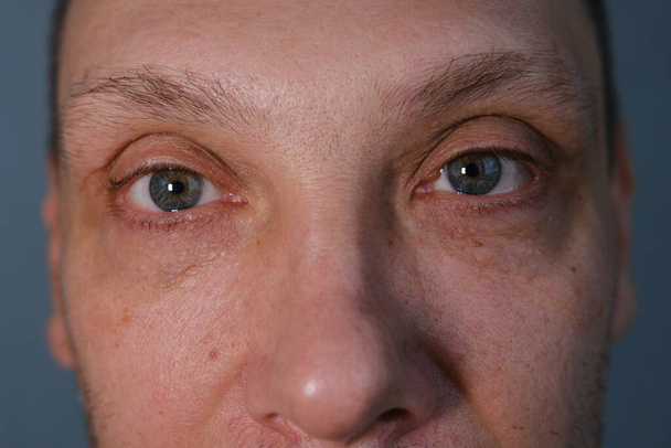 Middle-aged man face fragment, half man face, close up portrait of a middle aged man on grey background, grey eyes close up. - Фото, зображення
