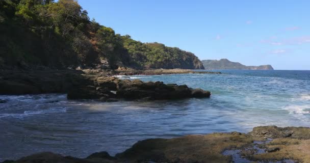 Playa Ocotal with Pacific ocean waves on rocky shore, El Coco Costa Rica. Famous snorkel beach. Picturesque paradise tropical landscape. Pura Vida concept, travel to exotic tropical country. - Footage, Video