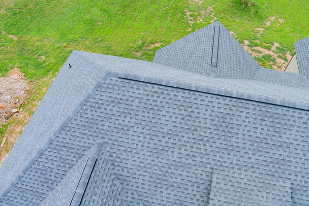 Roofing construction house rooftops covered with asphalt shingles an aerial view - Foto, afbeelding