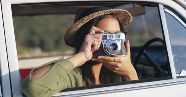 Woman taking picture with camera on nature road trip, on holiday in a car and transportation during vacation on travel by the countryside. Travel, happy and free person with freedom in summer. - Felvétel, videó
