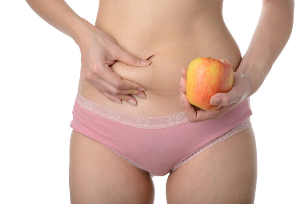 Hermosa mujer delgada sosteniendo manzana mientras comprueba su grasa, Dieta c
 - Foto, Imagen