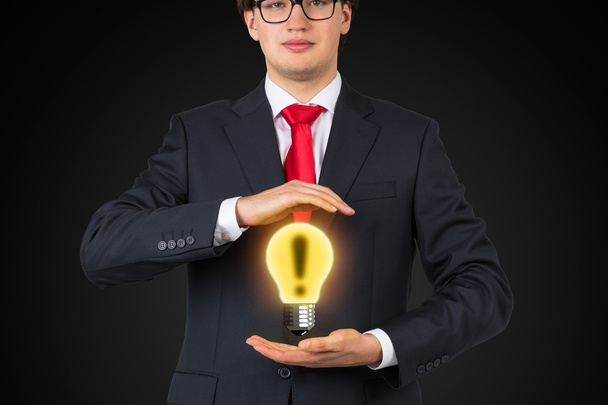 businessman holding lamp - Foto, imagen