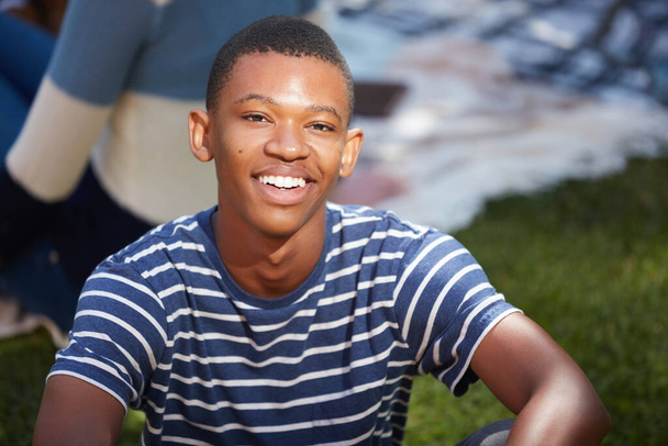 Feels good to get out for a midday break. Cropped portrait of a happy young man relaxing outside on campus - Foto, Imagen