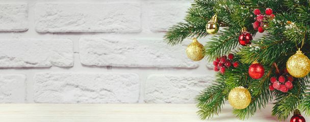 Decorated Christmas tree branch with snowflakes on white brick wall background. Banner for site, header for social media with copy space - Fotografie, Obrázek