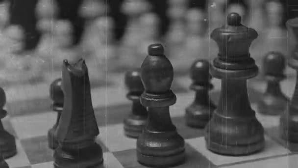 A game of chess being played with aged film overlay - Video