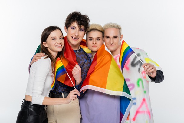 smiling people of diverse identity holding lgbtq flags and looking at camera isolated on grey - Фото, изображение