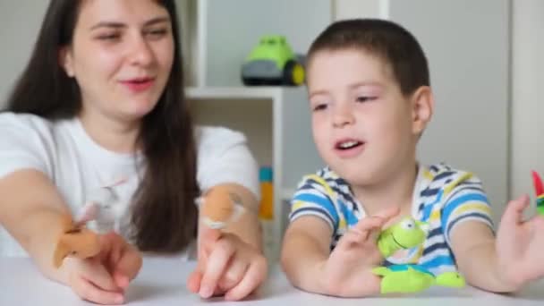 Mother and son play finger theater, toys on fingers - Materiał filmowy, wideo