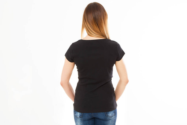 Advertising and T-shirt design concept. Cropped portrait of stylish woman wearing black T-shirt and blue jeans standing against white studio wall with copy space for your promotional content - Foto, immagini