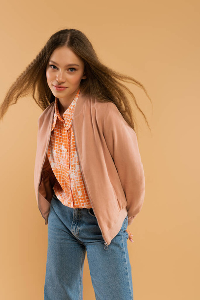 pretty teenage girl in autumnal and casual clothes posing isolated on beige - Fotoğraf, Görsel