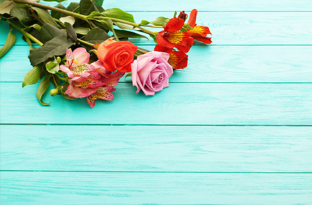 Flowers on blue wooden background. Valentines day. Top view and copy space. - Photo, Image