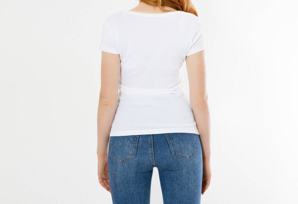 white t-shirt on a smiling girl : back view. Red hair woman with empty tshirt mock up - Fotó, kép
