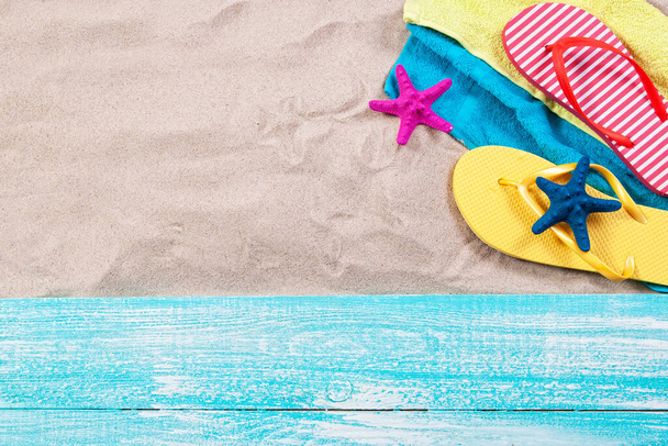Sand copy space. Sand background top view.Beach towel, beach slippers and starfish - 写真・画像